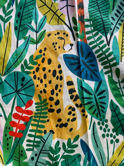 Colourful fabric pattern with a leopard and tropical leaves