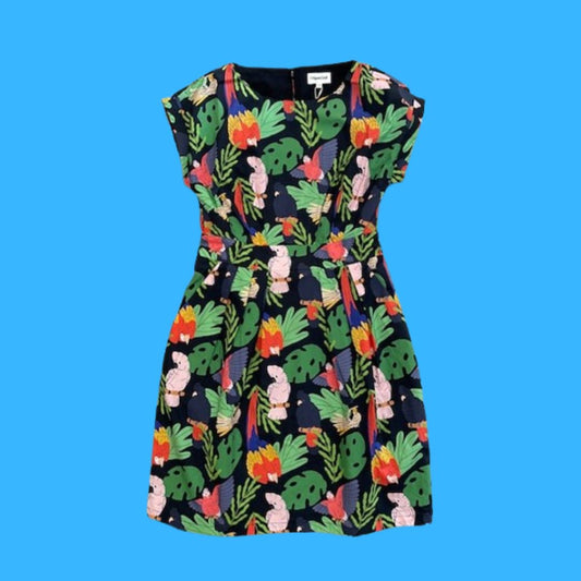 Dress with colourful tropical leaf and birds pattern on a blue background