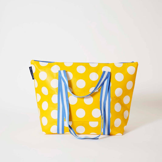 Project Ten Yellow Polka Dot Medium Zip Up Tote is a yellow tote bag with white polka dots and blue-and-white striped handles, photographed on a clean white studio background.