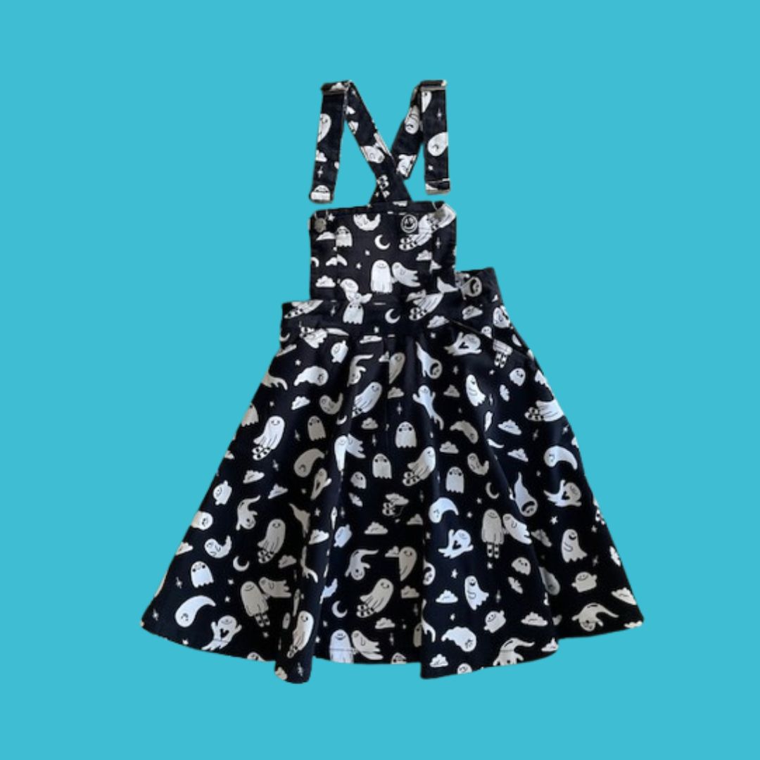 Black pinafore with white ghost pattern on a blue background