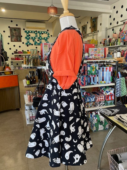 Side view of Mabel wearing a black dress with white ghost patterns in our Ruck Rover store