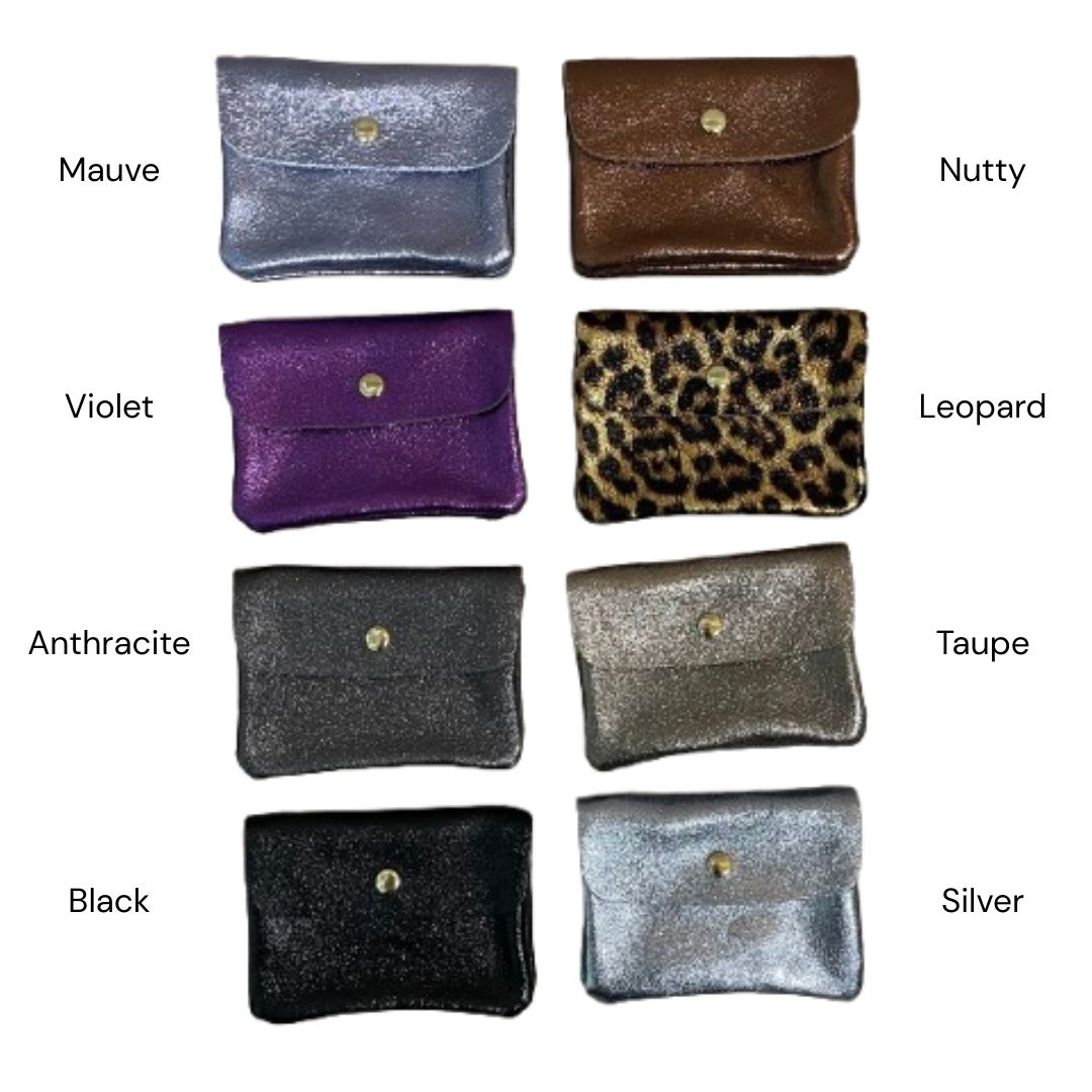 Eight small wallets arranged in a 4-by-2 grid on a white background, labeled with color names: Mauve, Nutty, Violet, Leopard, Anthracite, Taupe, Black, and Silver. The pouches show different finishes and patterns, including glitter, leopard print, and solid colors.