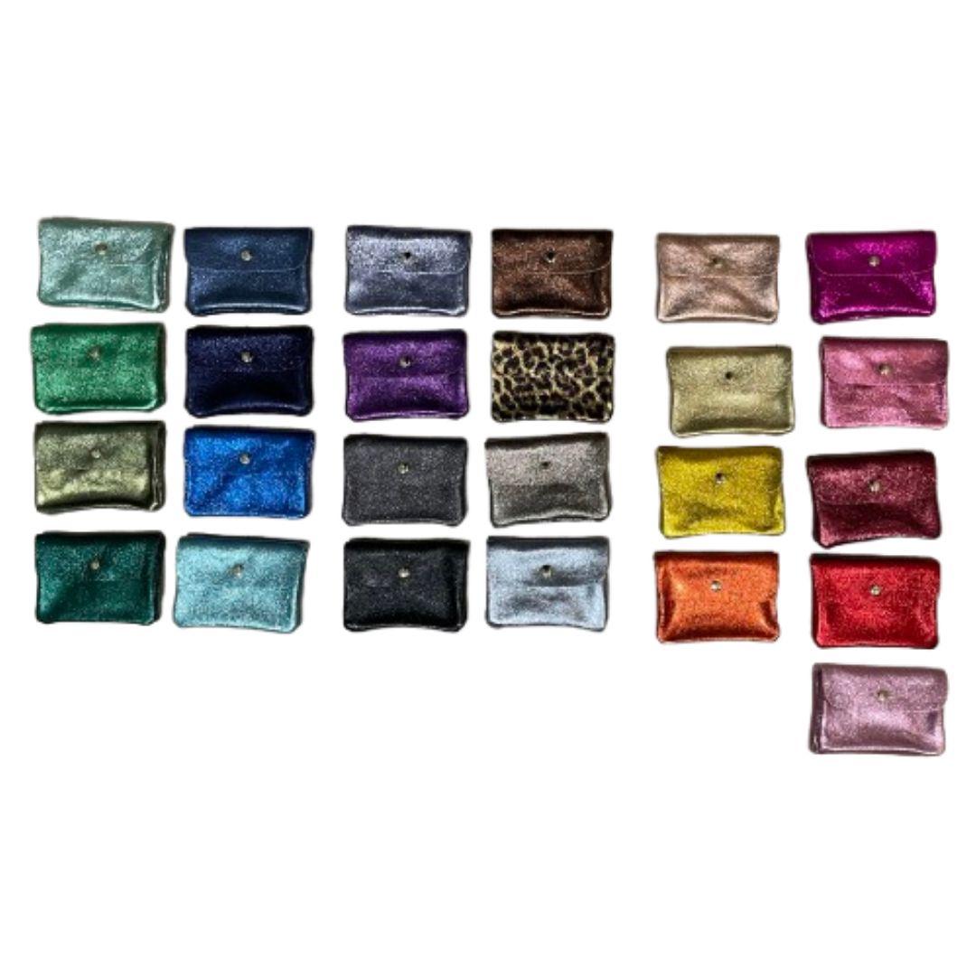 A collection of small rectangular metallic wallets arranged in rows on a plain white background, showing a variety of colors and textures including leopard print, and metallic finishes.