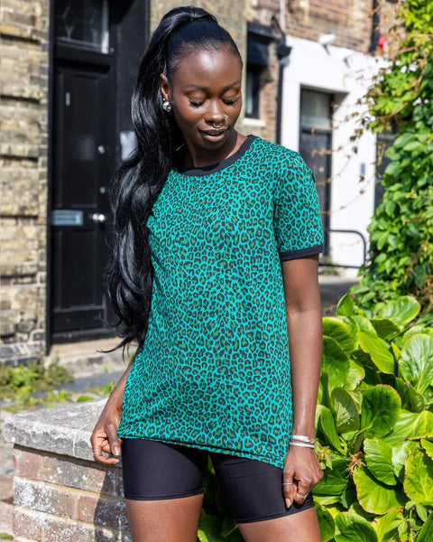 Model is wearing Run and Fly Leopard Tee Shirt in Teal and paired with black shorts.

