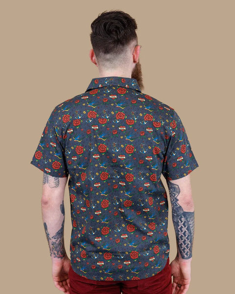 Back view of model wearing a Run and Fly Retro Tattoo Print Shirt.